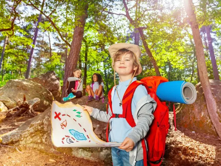 Little boy with treasure map in the forest game
